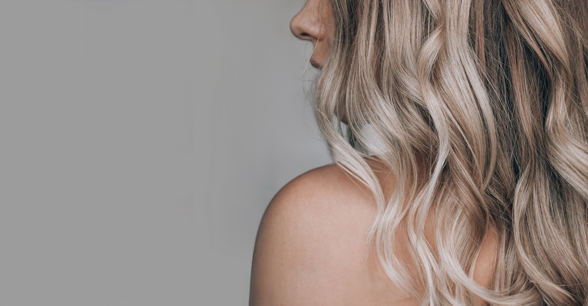Soft, blended balayage waves in sandy and pearl blonde